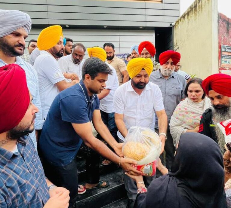 Punjab Revenue, Rehabilitation and Disaster Management Minister Hardeep Singh Mundian distributing essential dry ration among flood-affected families in Sasrali village of district Ludhiana.